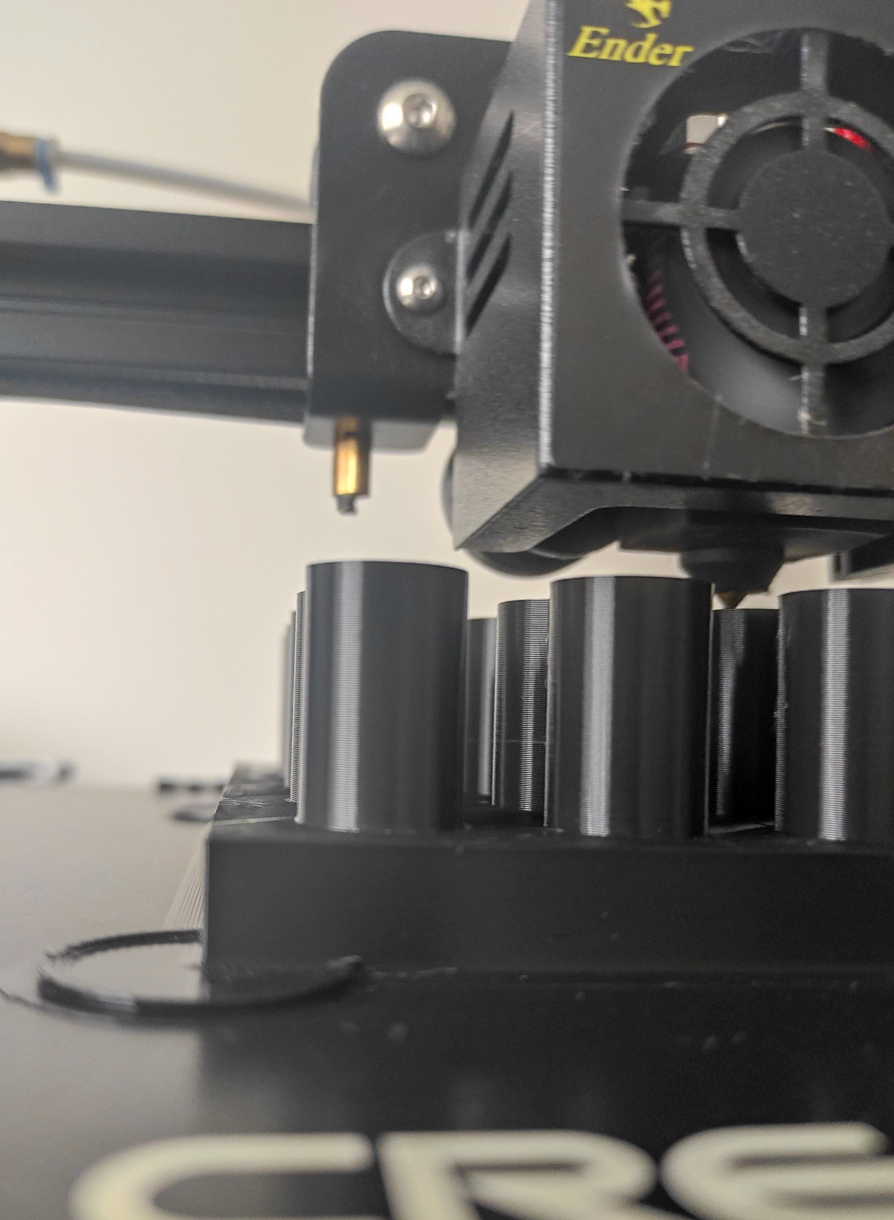 3D printer mid print producing part of a mold press.