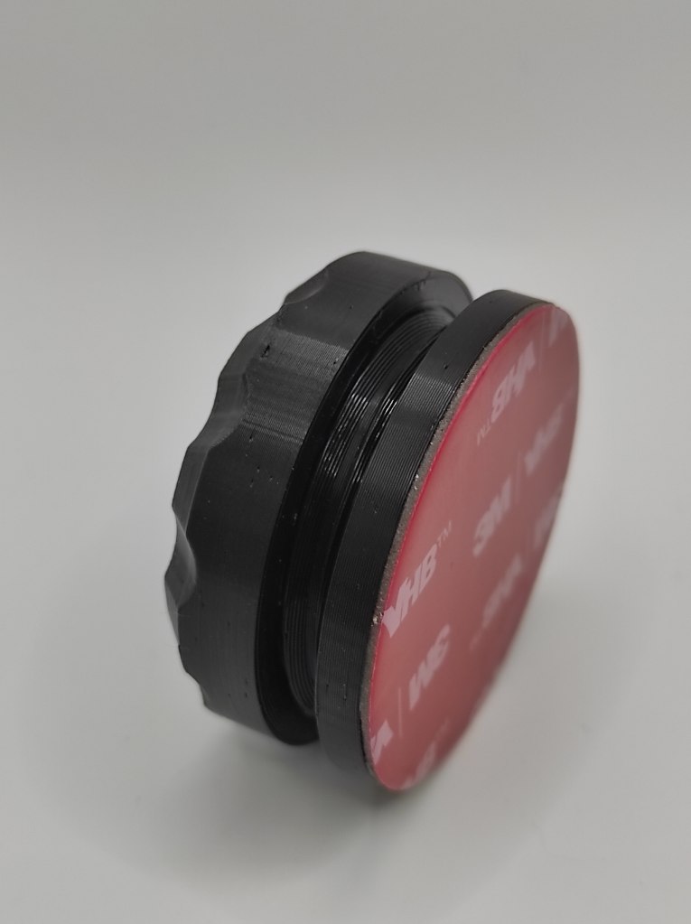 ToolTag on it's side half unscrewed showing sticky pad