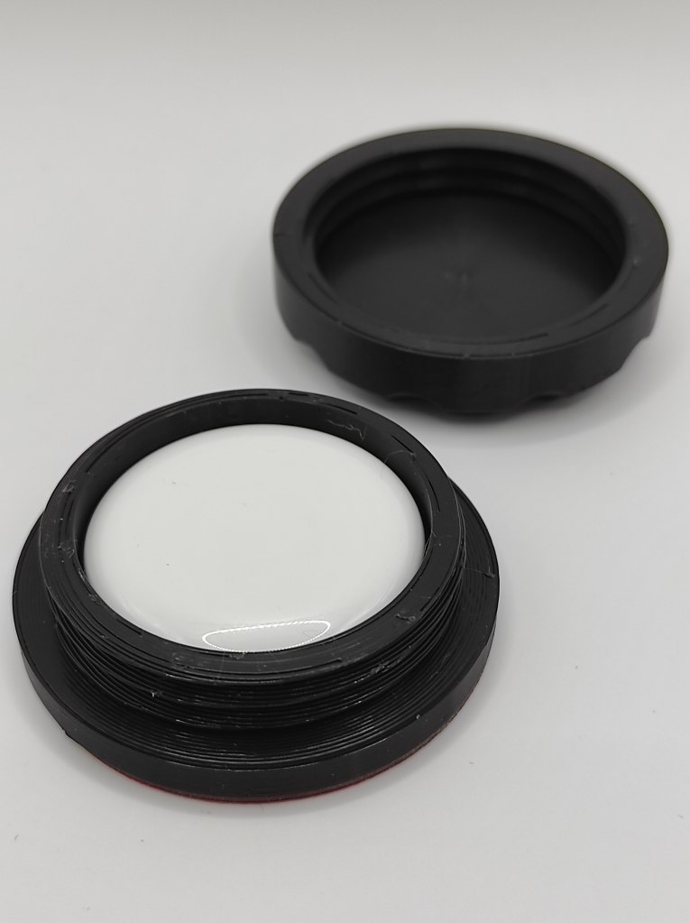 Apple Airtag inside one half of a ToolTag