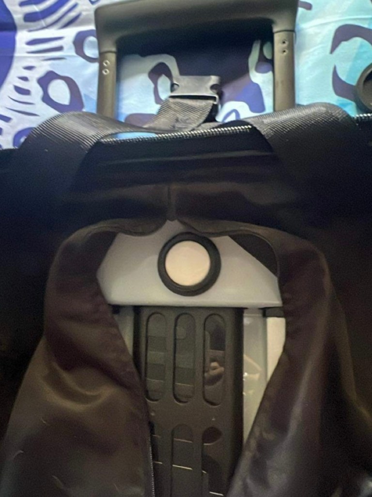 ToolTag with lid off inside lining of a suitcase showing an installation suggestion.