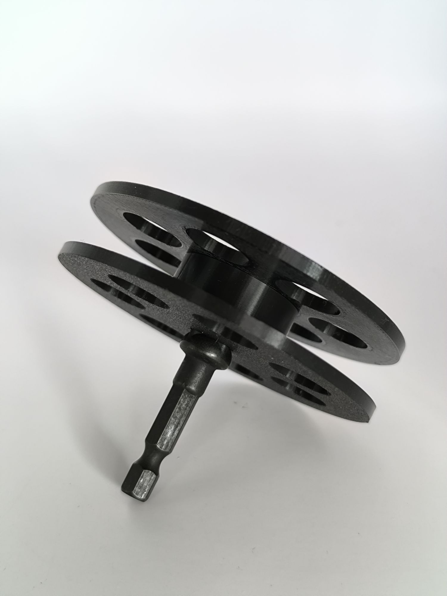 3D Printed fishing line holding reel with 3/8 driver attached.
