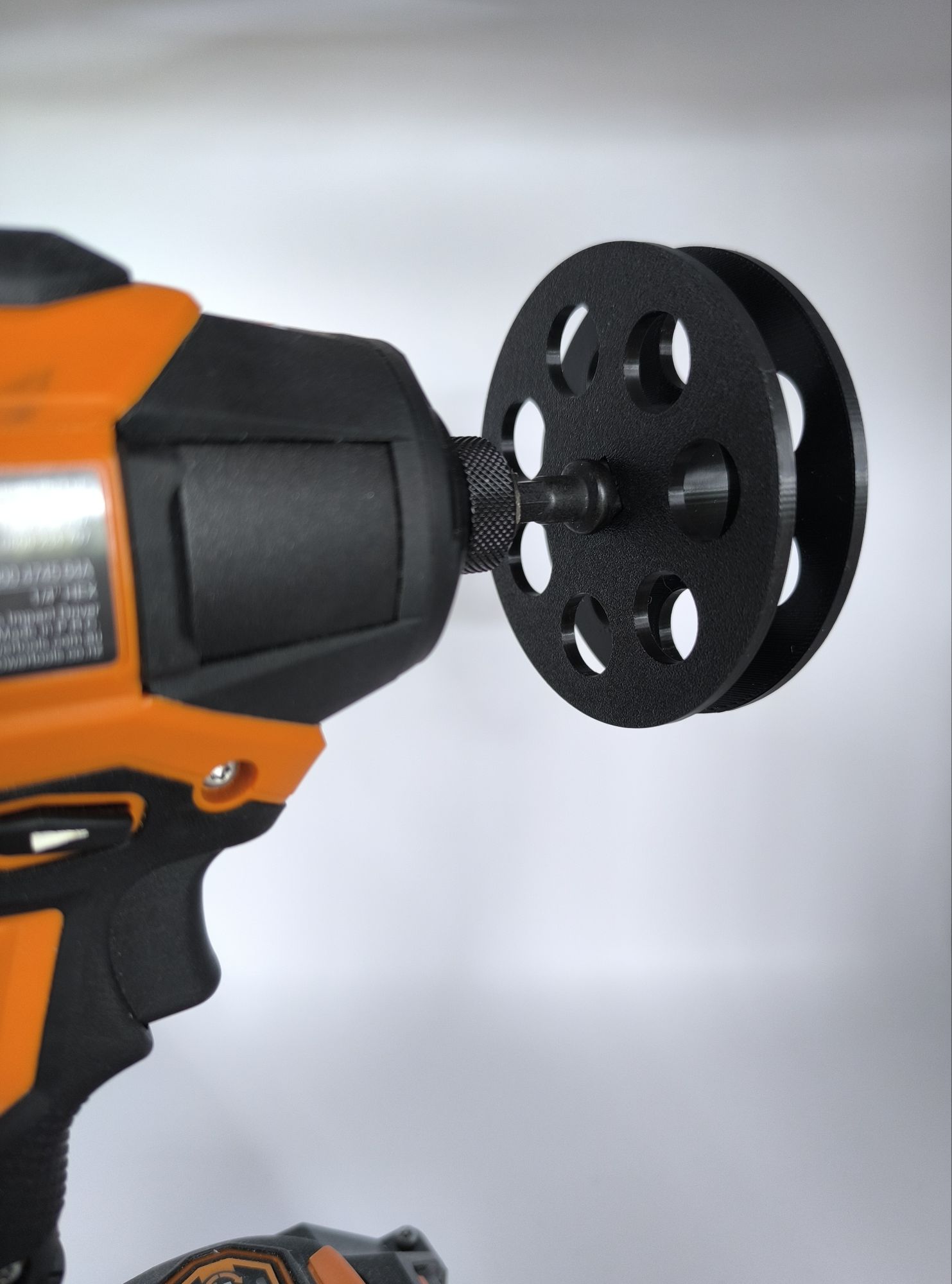 3D Printed fishing line holding reel with 3/8 driver attached to drill.
